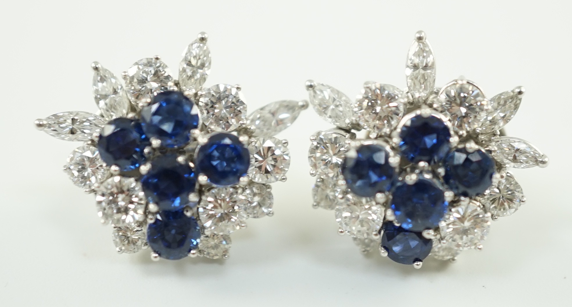 A pair of modern 750 white gold, set sapphire and diamond cluster ear studs